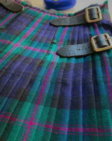Kilt After Pressing And Pleat Adjustment Kilt after alteration, steaming, pressing, pleat adjustment, and re - stitching